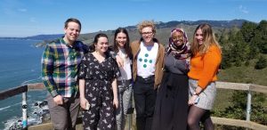 5 students from Spring Break in Silicon Valley standing on a hiking path overlooking the Pacific Ocean.