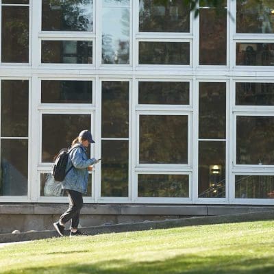 A student walks outside of Hinds Hall