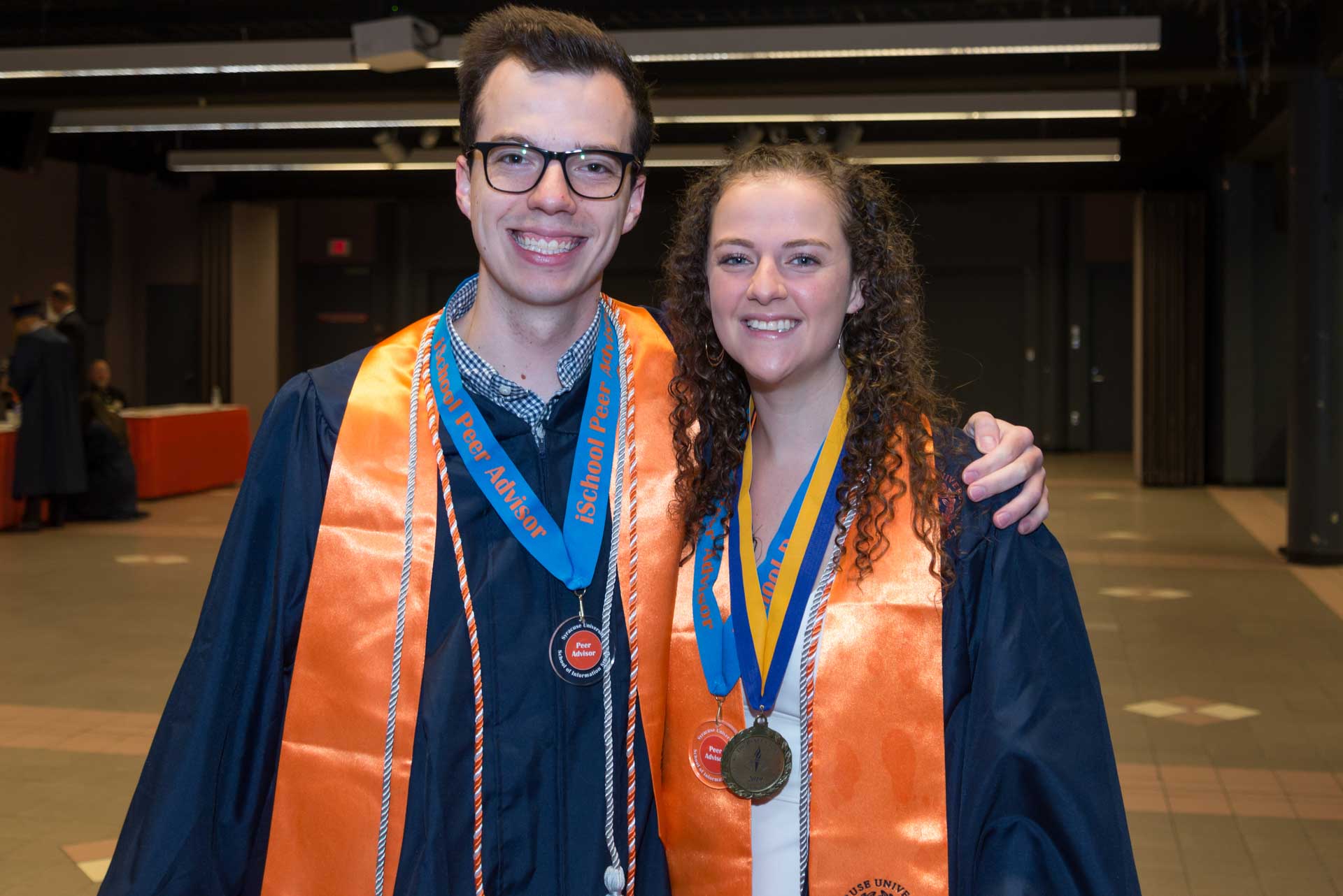 Two students together at 2019 graduation