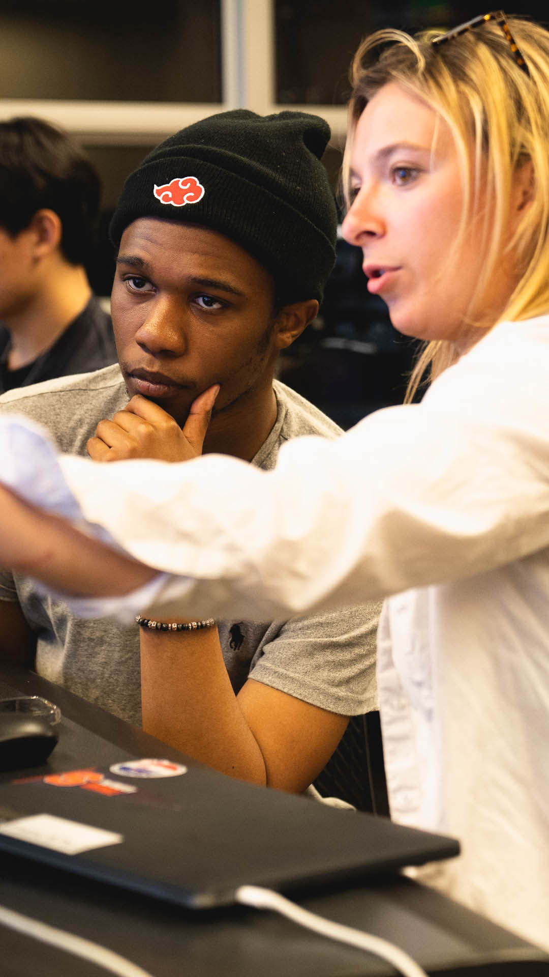 Boy thinking while a girl is explaining something on her computer