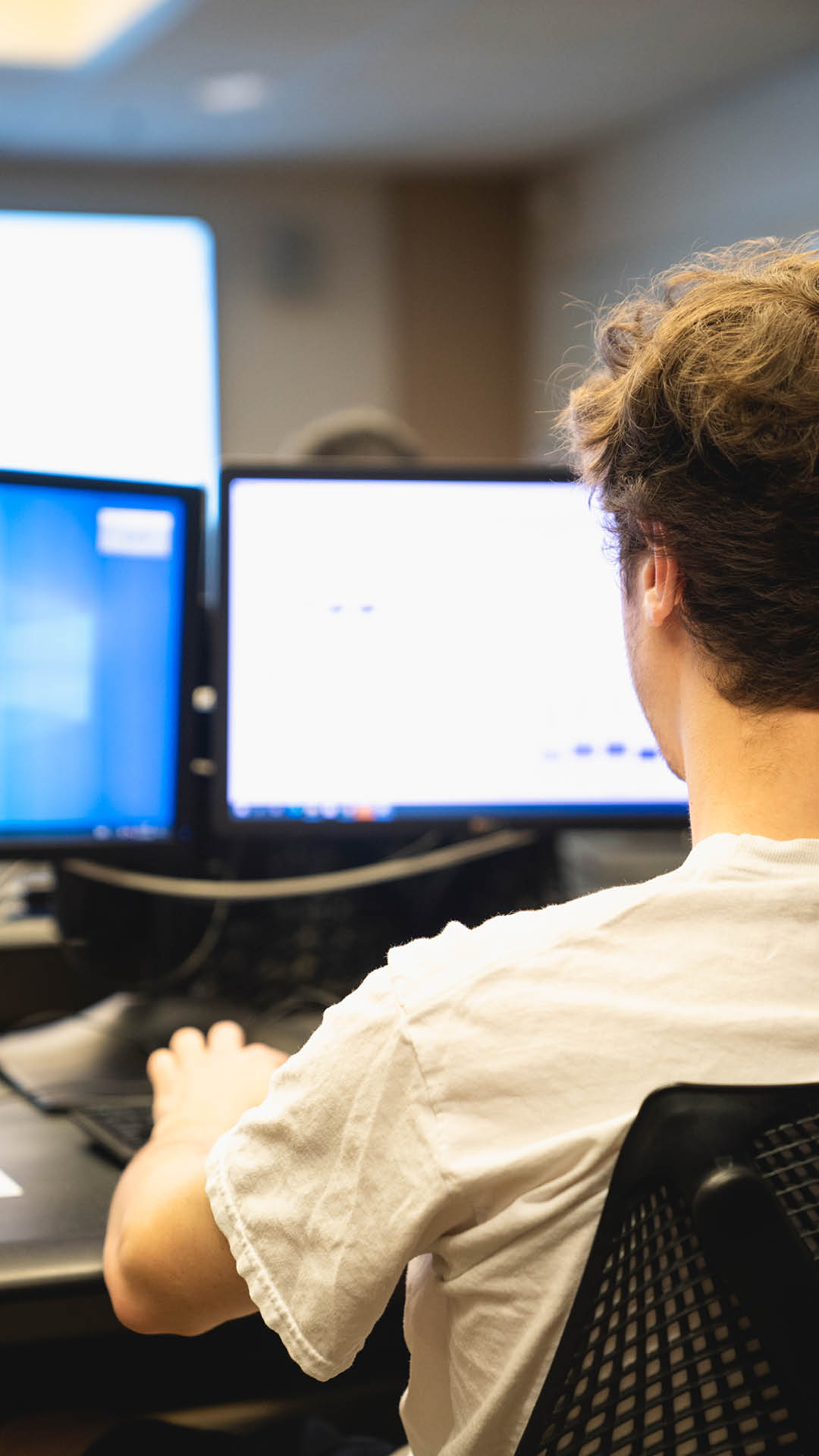 boy focused on the computer from the back