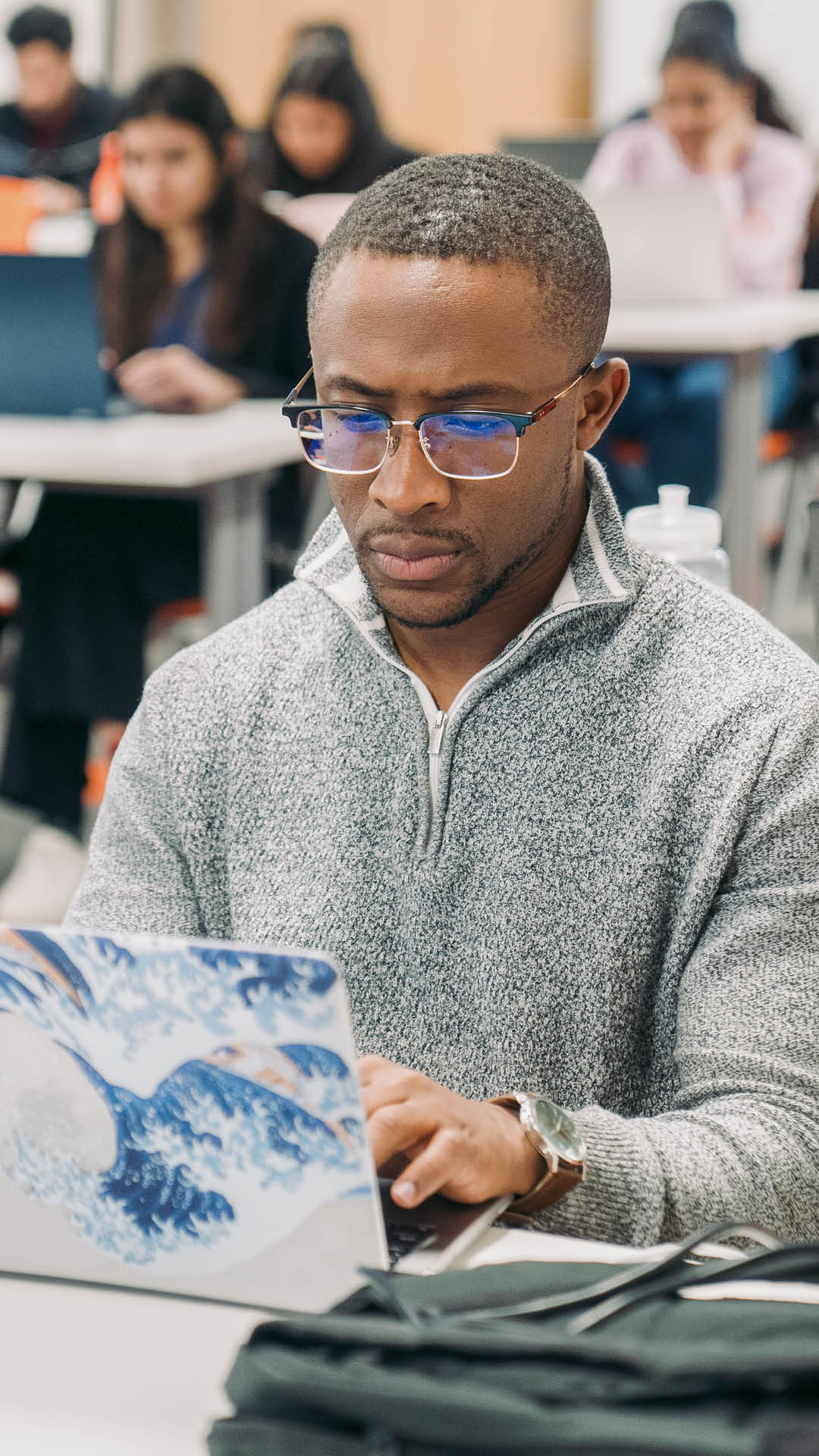 man looking at his laptop