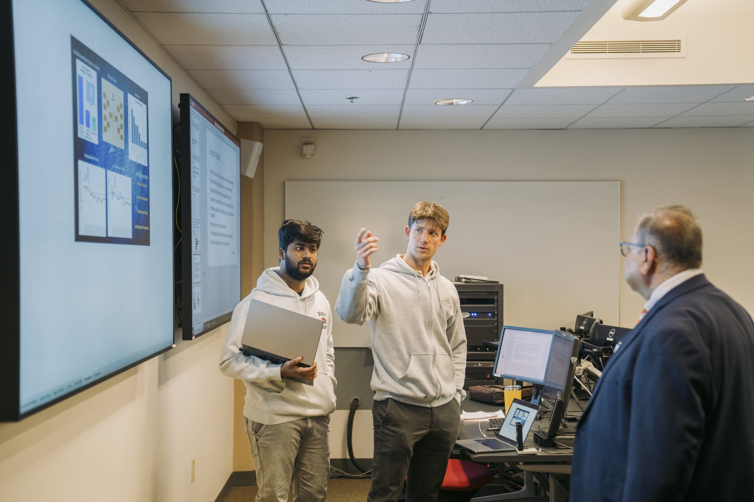 two students presenting in front of the classroom