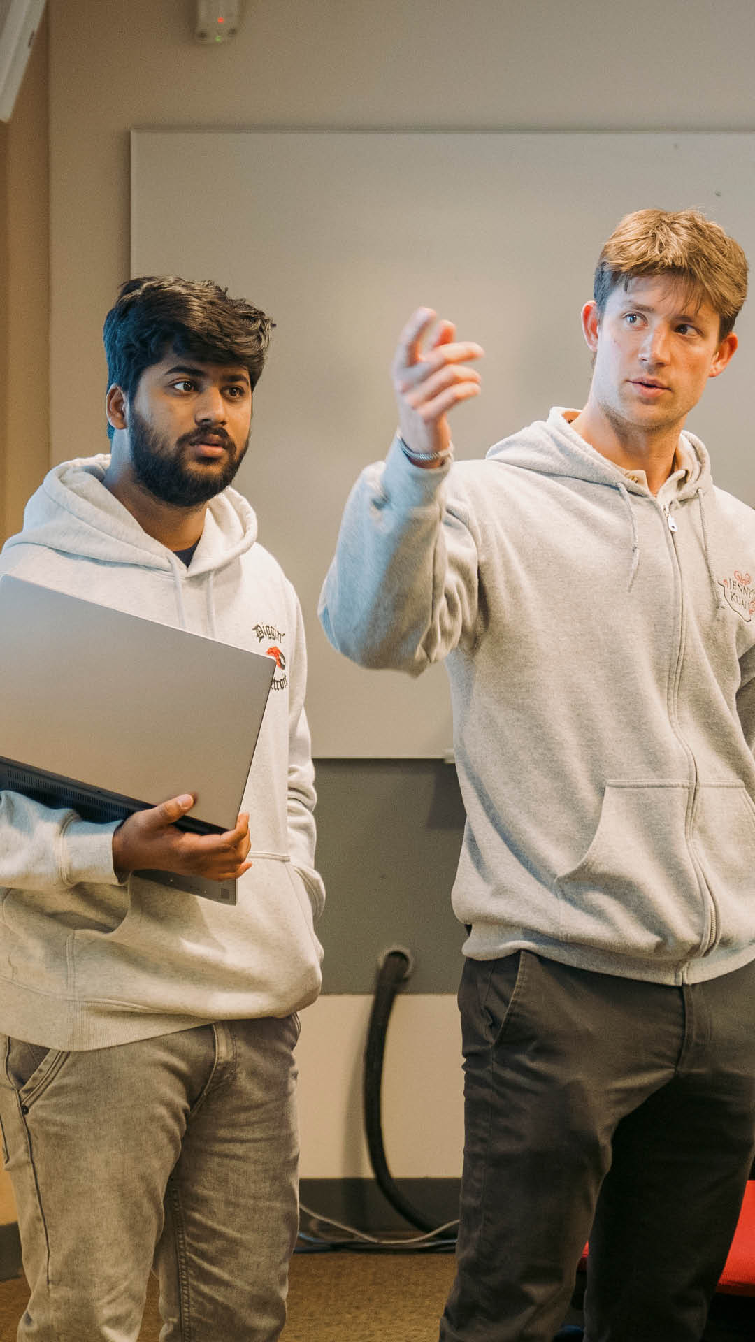 two men presenting in front of a classroom