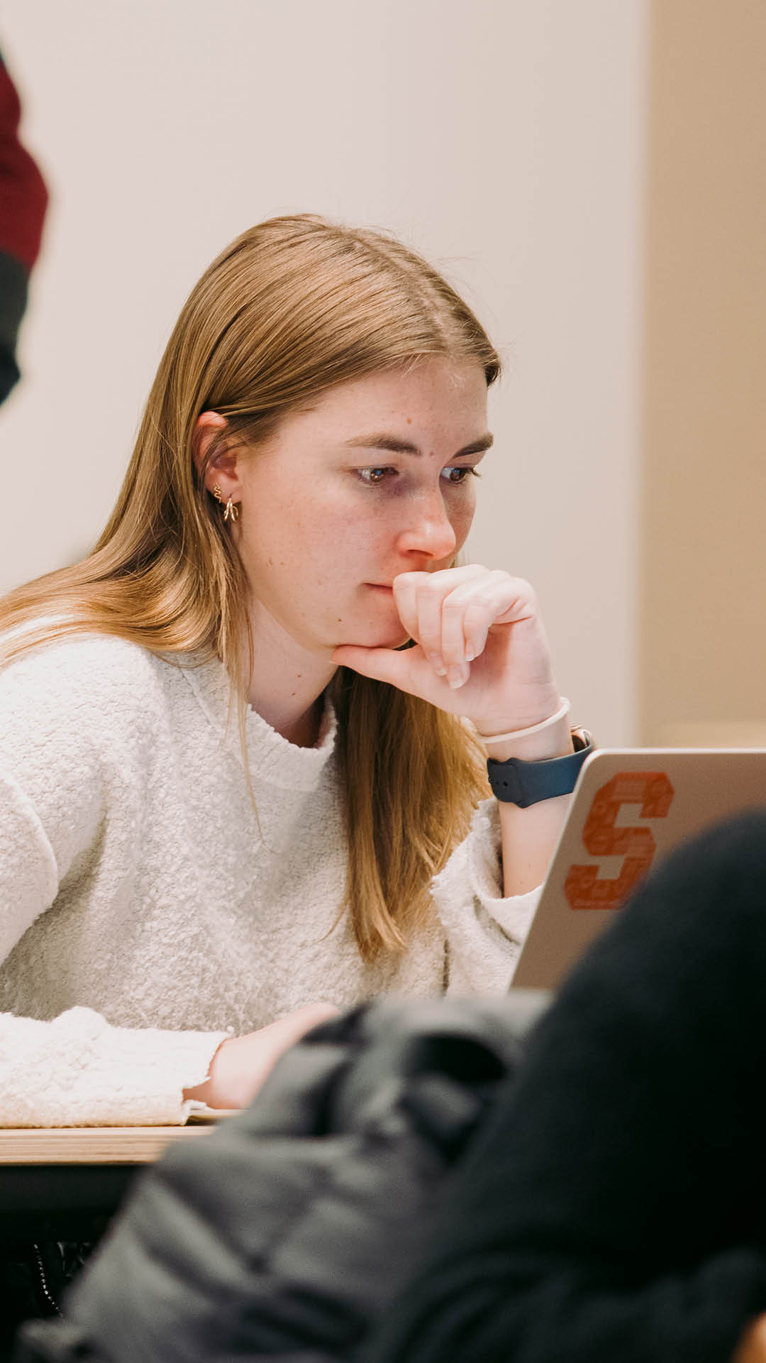 young woman studying on laptop